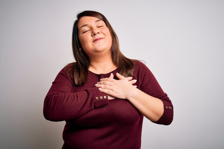 A woman connecting with and appreciating her body