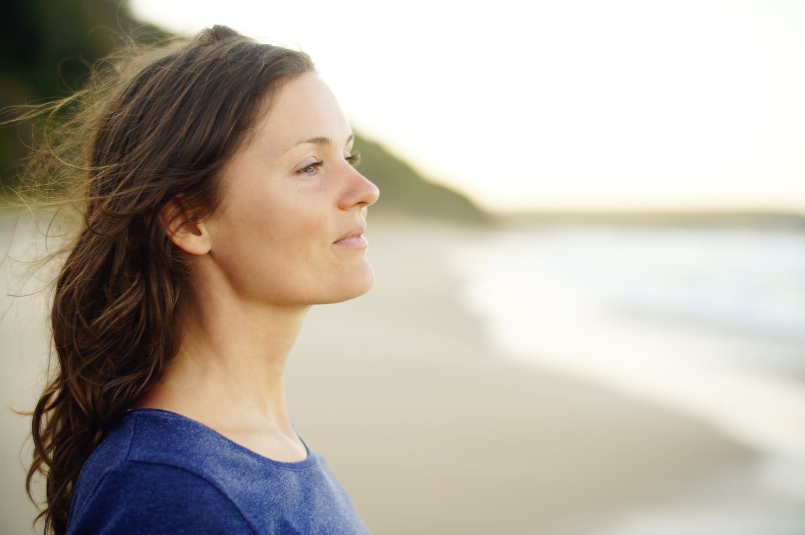 A woman pausing peacefully beside the water