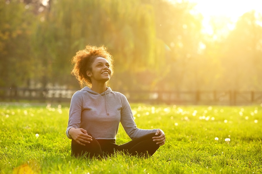 A woman sitting comfortably and smiling